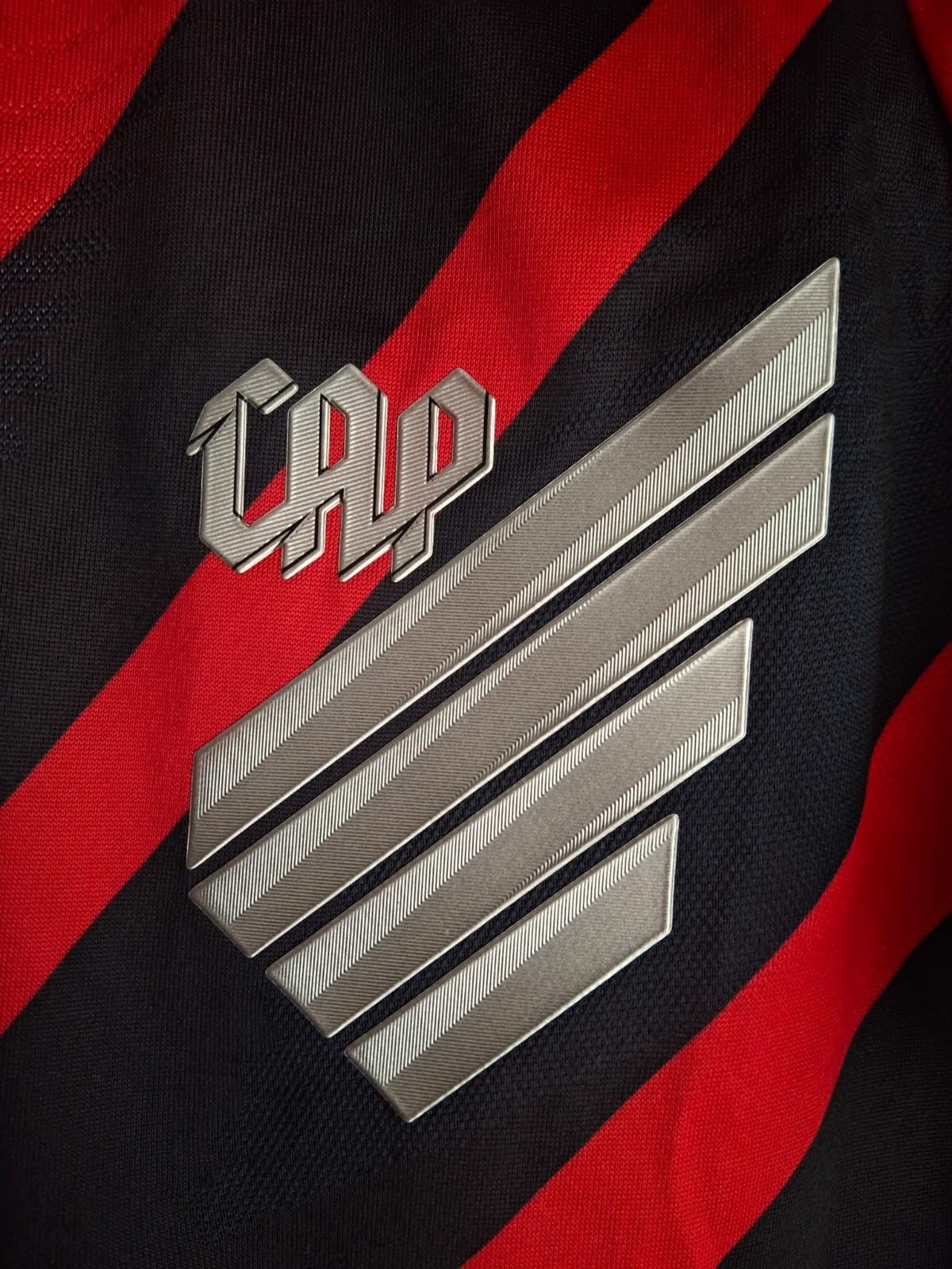 Garrincha Shirts Athletico Paranaense 2024 home jersey featuring a silver CAP crest on red and black diagonal stripes.