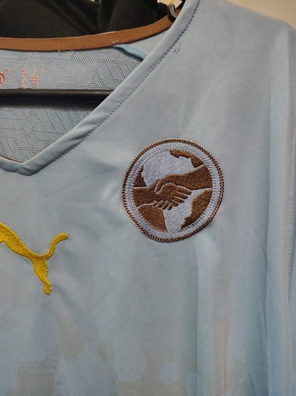 Camisa Puma Africa Unity 2010 – escudo do aperto de mãos